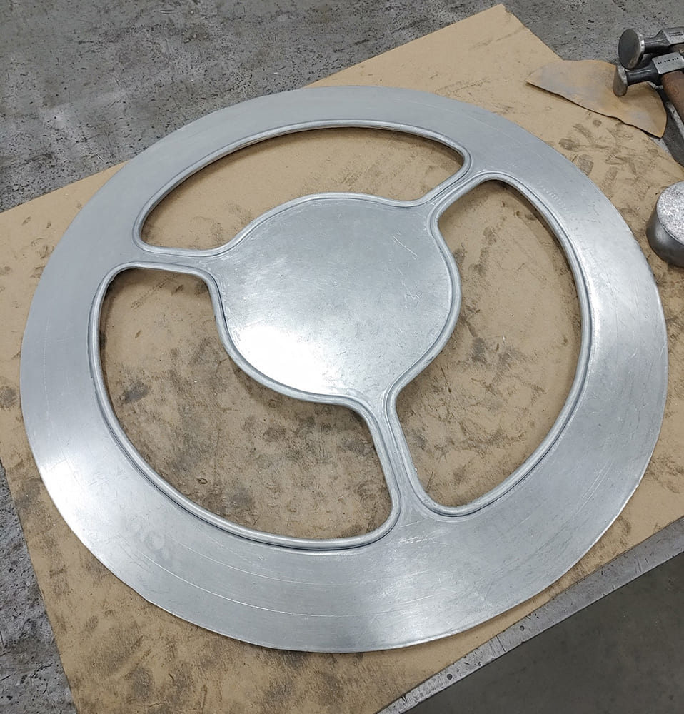 02 Divco custom wheel cover raw aluminum machined three spoke design