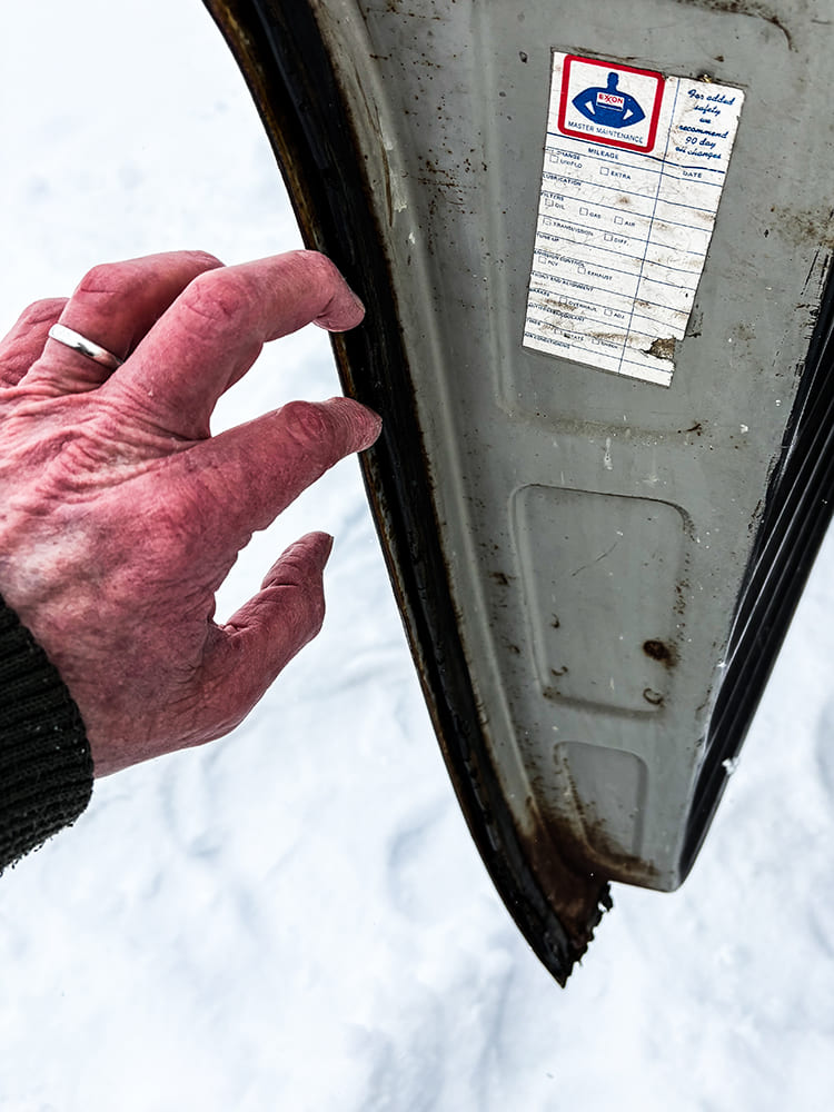 05 Old Chevy truck door with original worn weatherstripping in snowy conditions