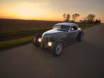 06 1936 Ford highboy rolling at dusk with louvers pie cut fenders and minimalist trim