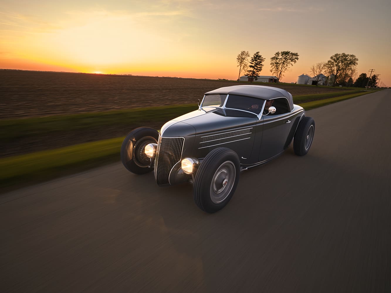 06 1936 Ford highboy rolling at dusk with louvers pie cut fenders and minimalist trim
