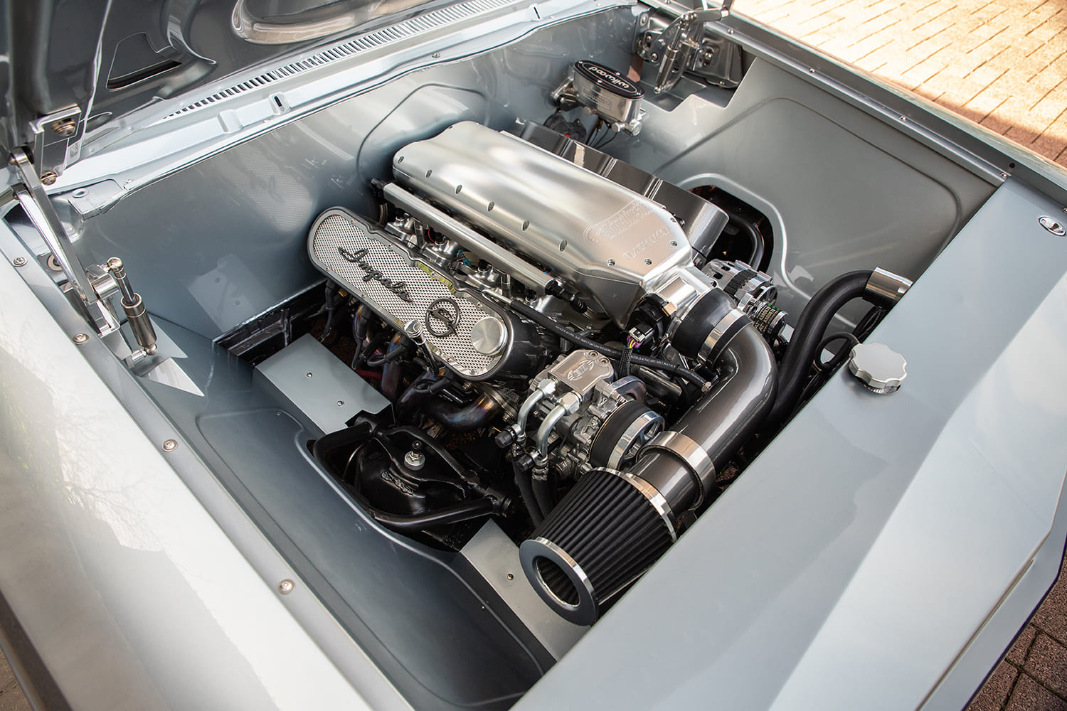 06 1962 Chevy Impala engine bay with billet intake manifold and custom Impala valve covers