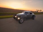 07 1936 Ford highboy roadster cruising into sunset with aggressive stance and smoothed body lines