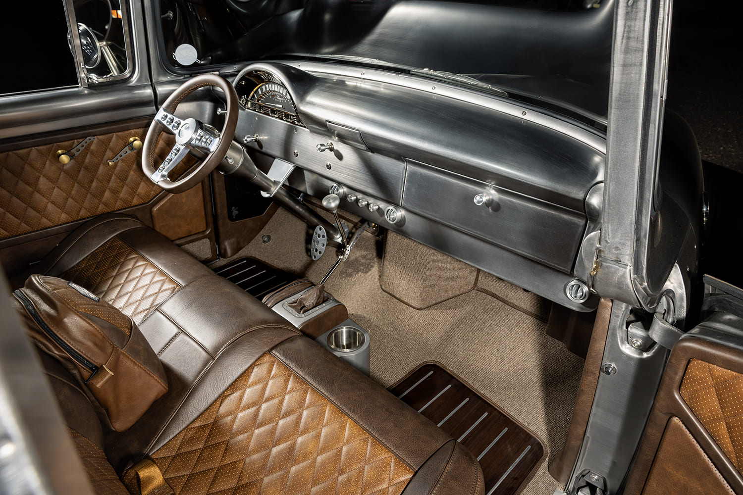 10 1956 Ford F 100 interior with diamond stitched leather bench seat and brushed aluminum dash