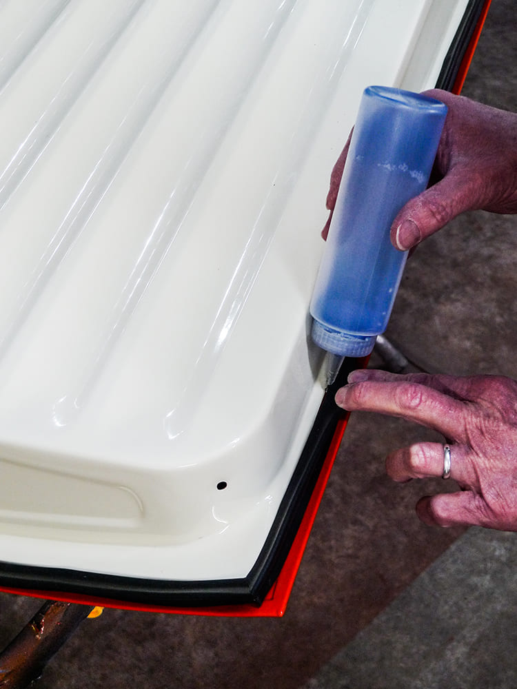 11 Chevy truck door seal lube application with clear blue plastic squeeze bottle