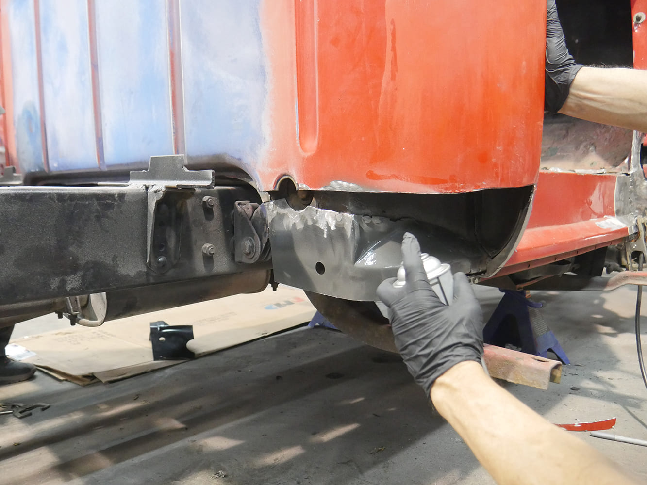 12 1956 Ford F 100 sanding final filler layer on new lower cab corner before primer coat