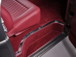 12 1957 Ford F 100 lower door jamb showing burgundy carpet seat base and chrome sill trim