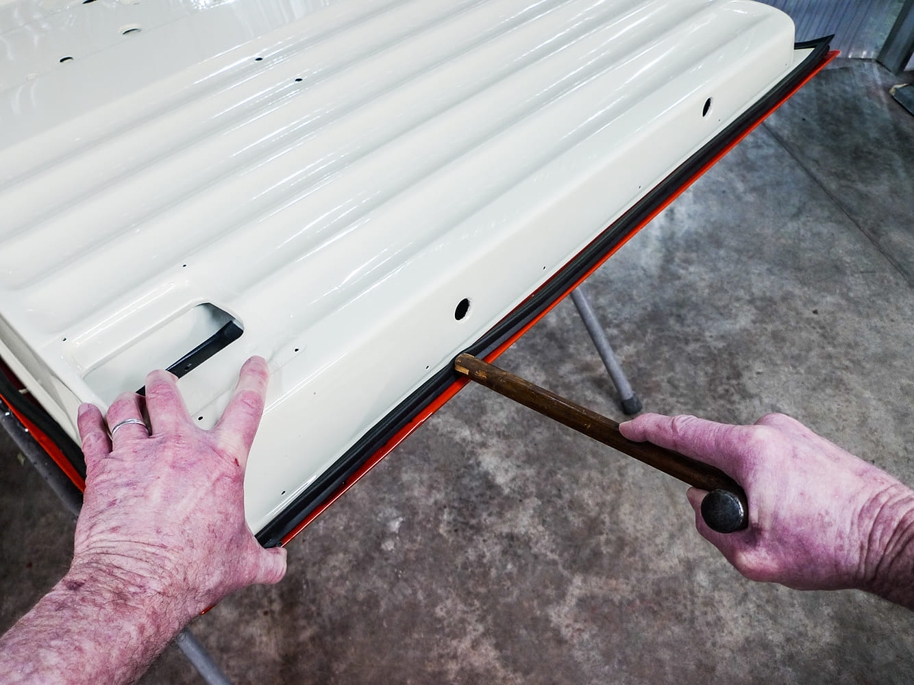 12 Using wood tool to press seal into door channel on classic Chevy truck