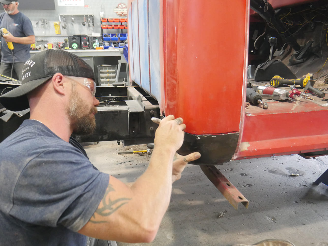 13 1956 Ford F 100 smoothing lower cab welds using air sander for panel blend