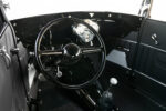 14 1929 Ford Tudor black interior with classic three spoke wheel and chrome gauge cluster