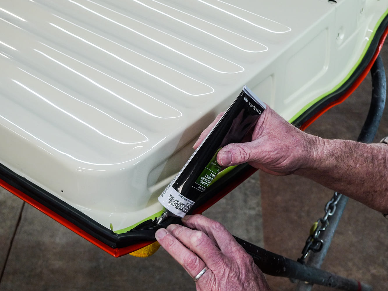 14 Applying 3M black weatherstrip adhesive to seal on Chevy truck door