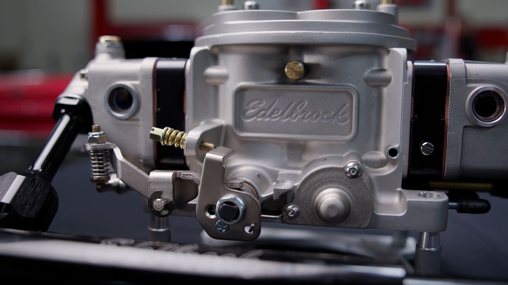 14 Edelbrock VRS 4150 front throttle arm and return spring assembly in raw aluminum