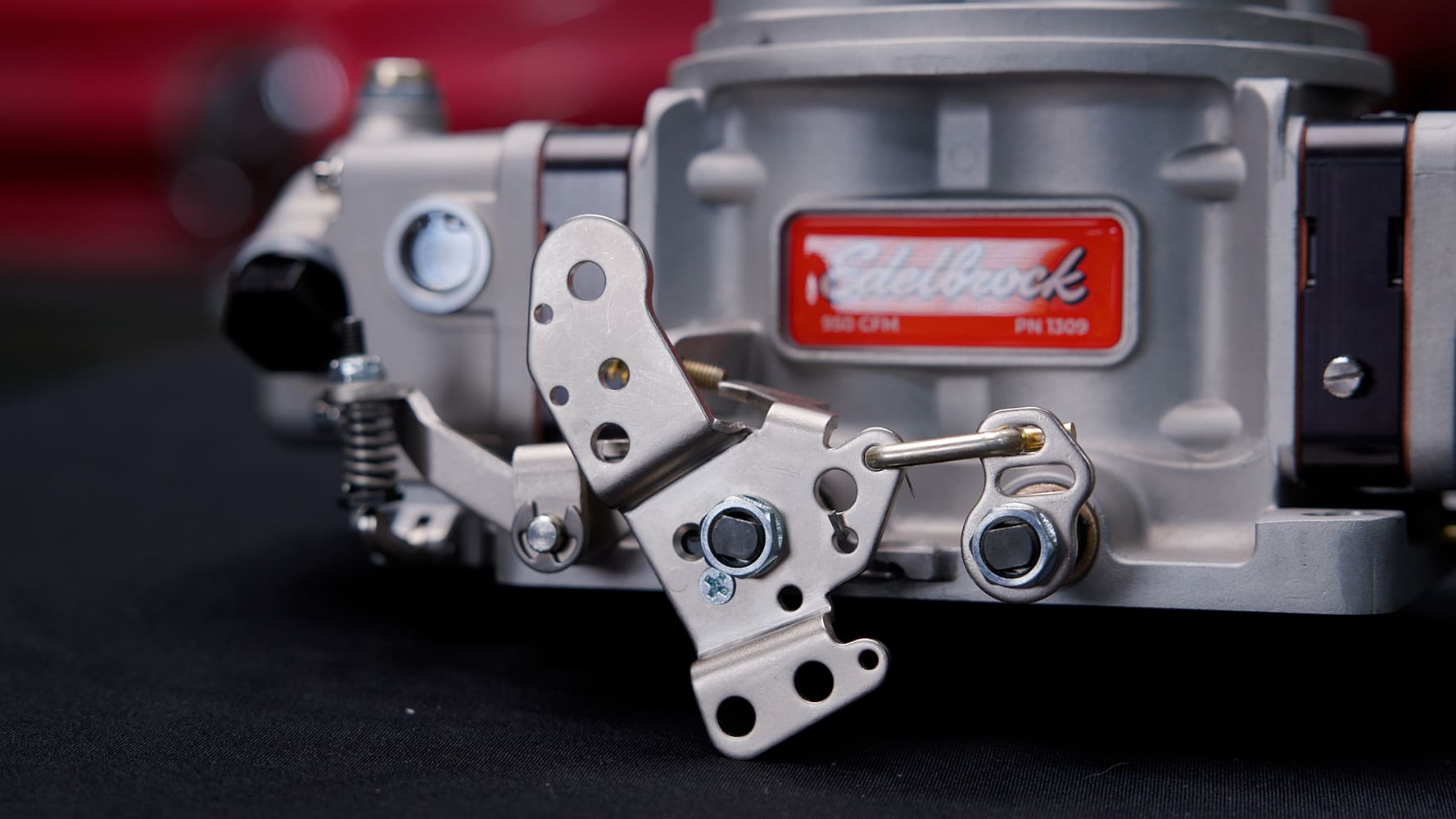 15 Edelbrock VRS 4150 rear linkage and throttle bracket mounted with part number tag