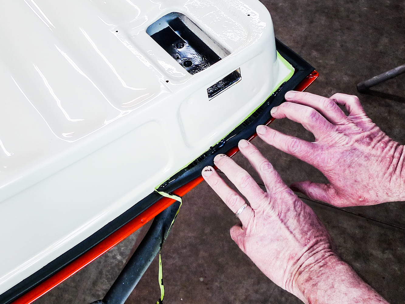 15 Hand pressing door seal into adhesive on classic Chevy truck panel