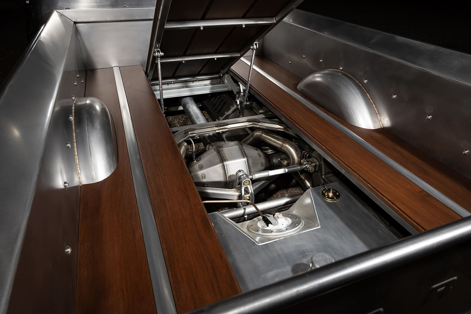 17 1956 Ford F 100 bed with hinged wood panels revealing custom rear suspension and fuel cell
