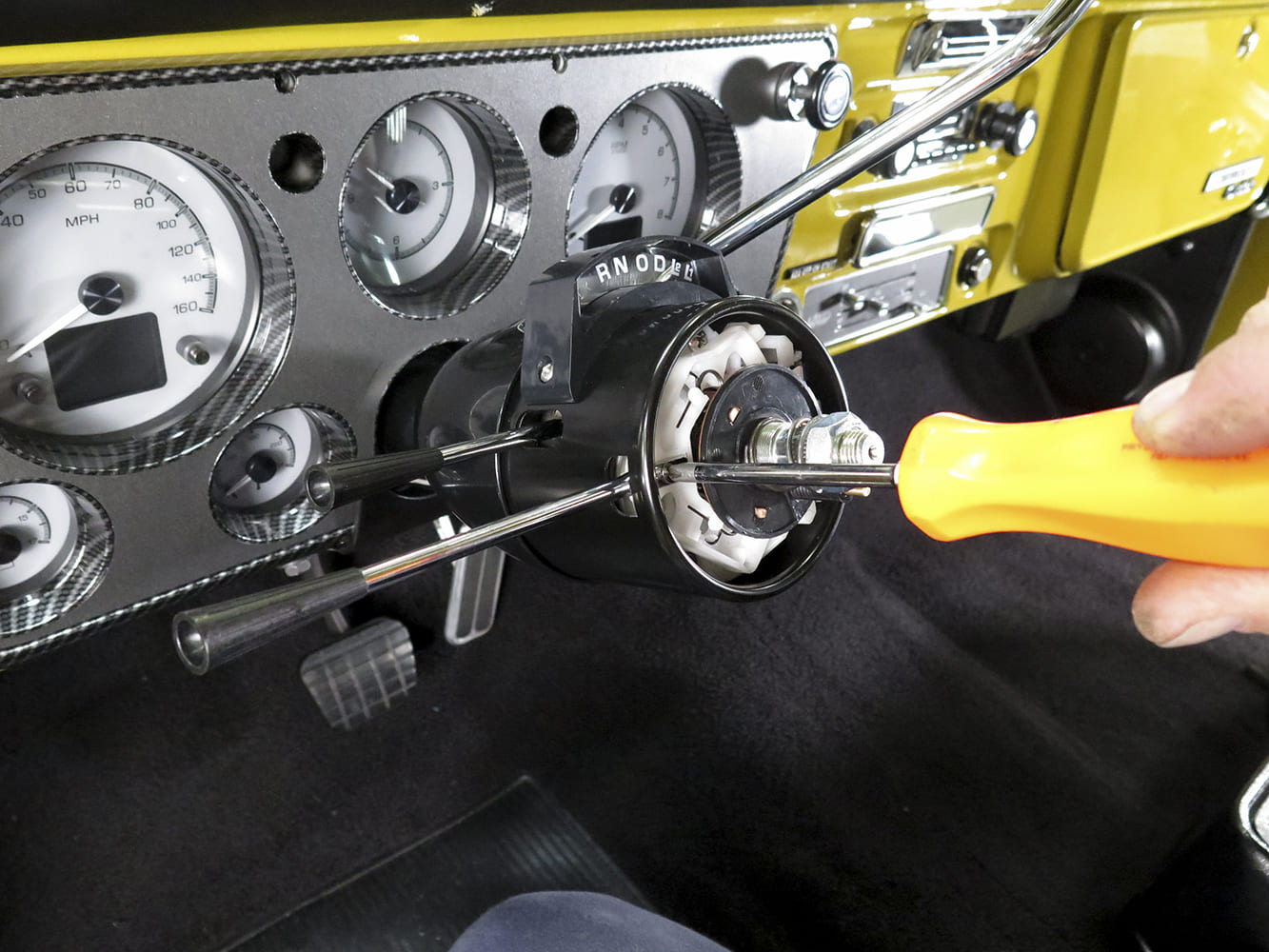 17 1972 Chevy C10 tilt column turn signal housing being tightened into gauge bezel mount