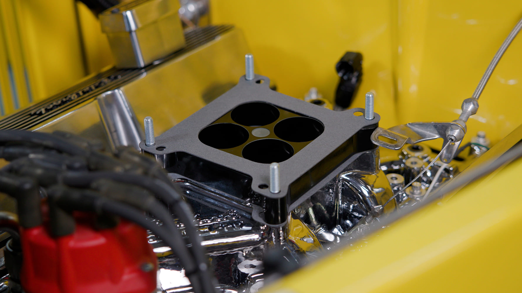 17 Close up of 4 hole spacer plate installed on Edelbrock intake with stainless hardware