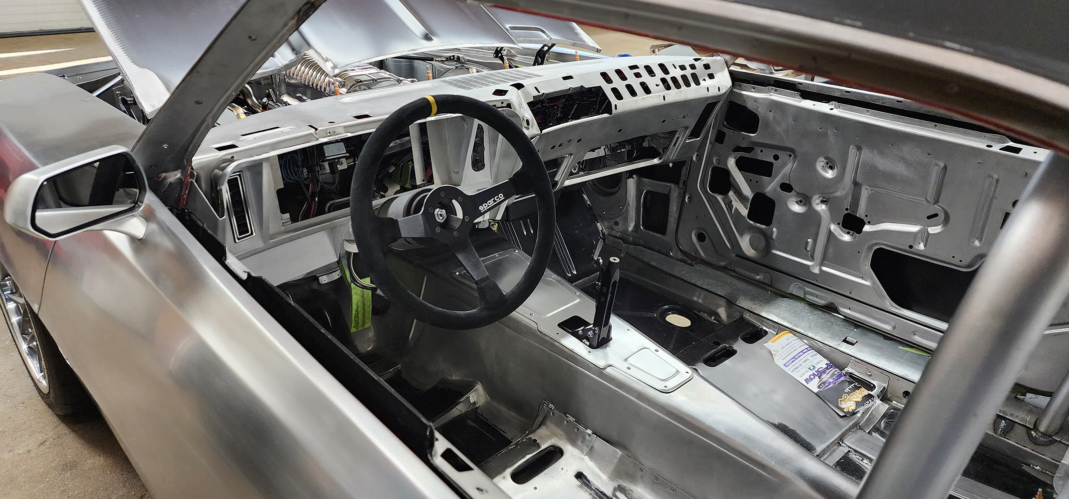 18 1969 Camaro bare interior view Sparco wheel and aluminum trans tunnel