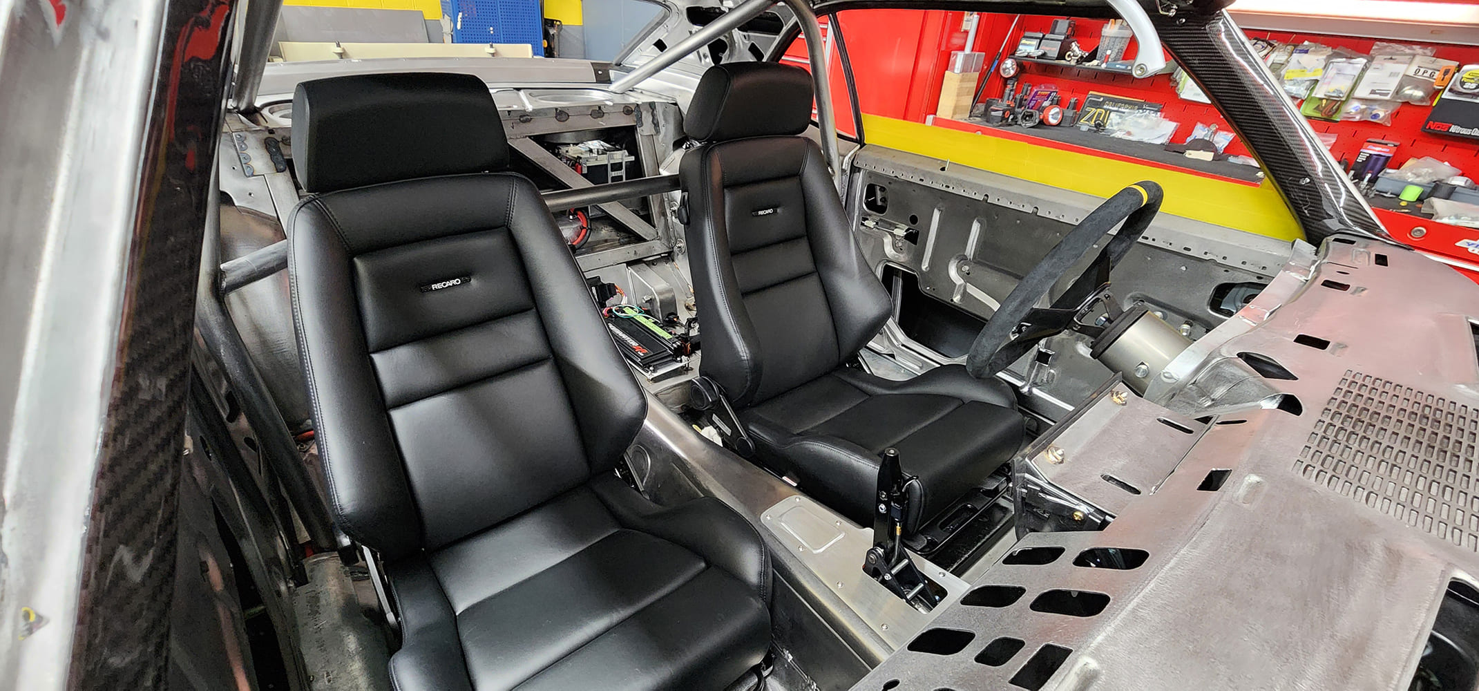 19 1969 Camaro Recaro interior seats with visible cage and battery relocation