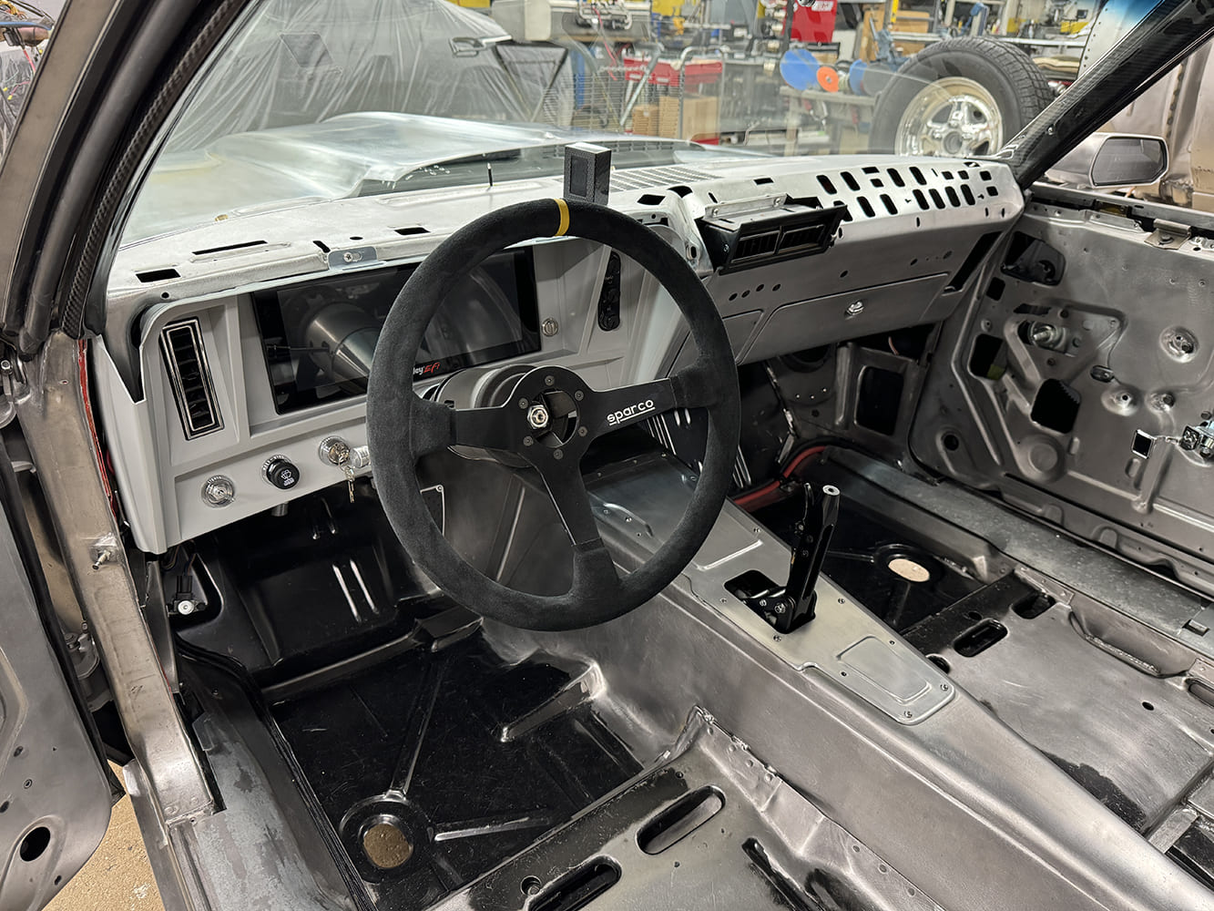 20 1969 Camaro dash layout Sparco wheel with digital display and raw interior panels