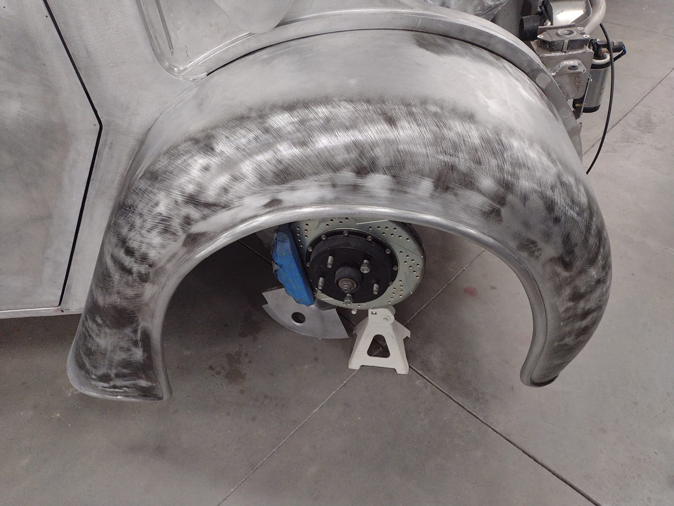 20 Divco brushed metal front fender shaped and test fit over Wilwood rotor setup