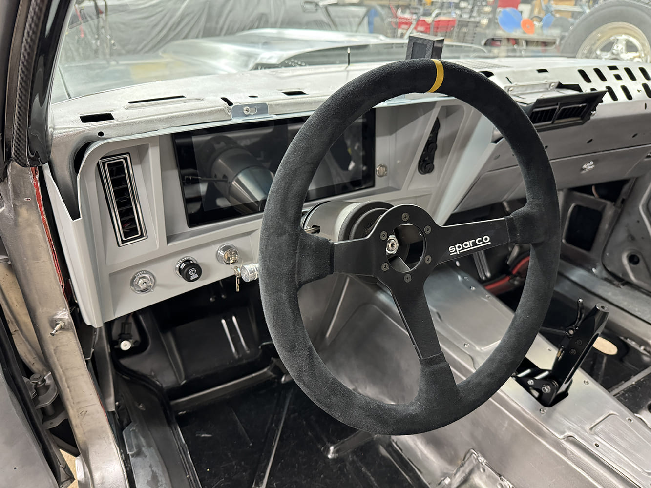 21 1969 Camaro digital dash with Sparco wheel and billet switch panel