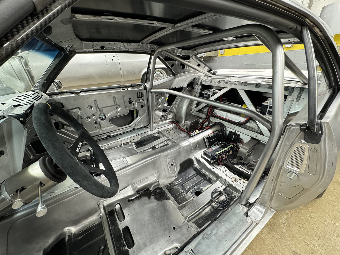 22 1969 Camaro full cage interior with raw panels and wiring in progress