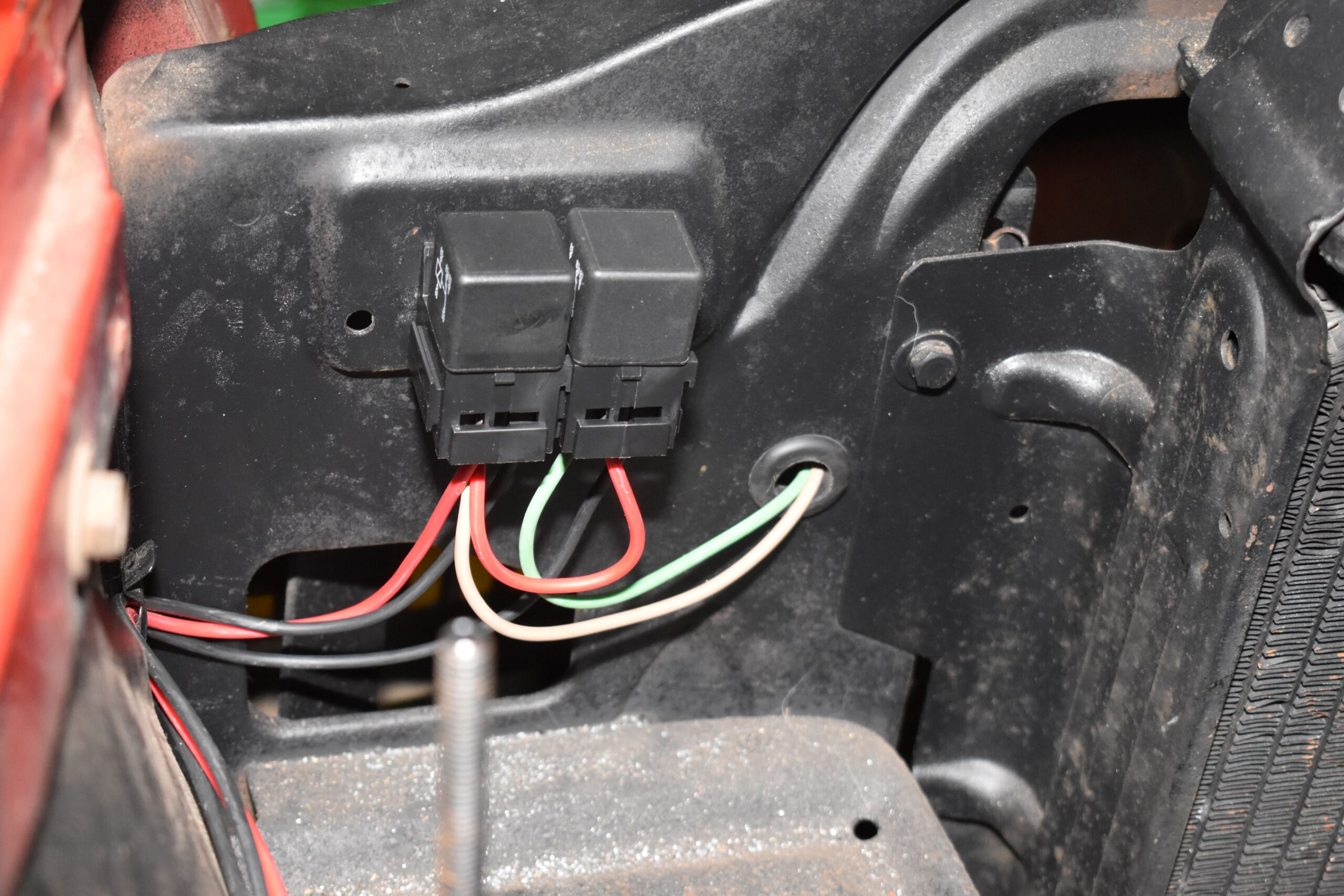 23 mounted relays on inner fender wiring harness routed with firewall grommet