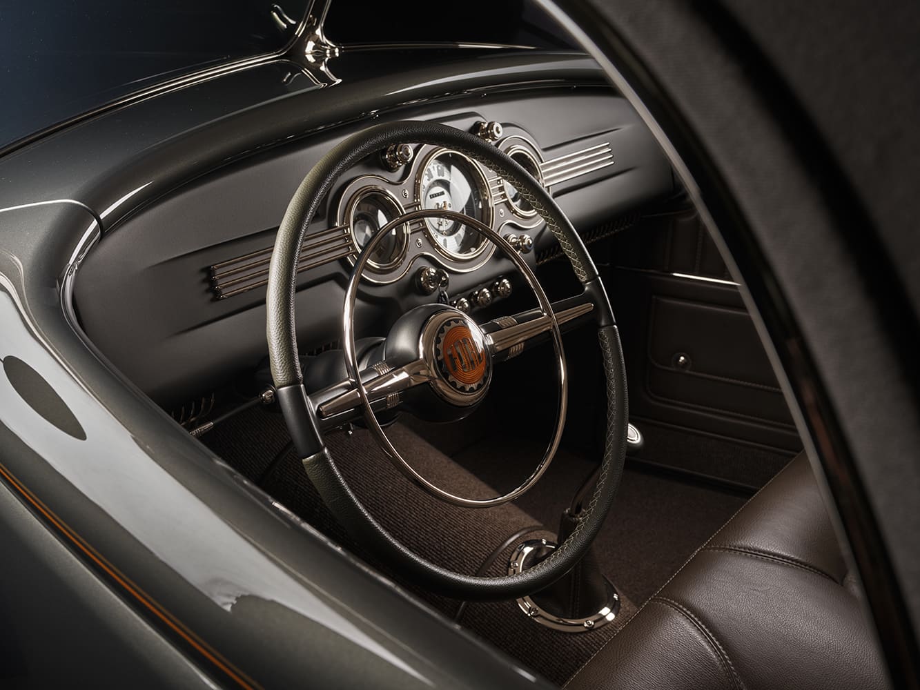 25 1936 Ford highboy interior view showing split bench chrome tilt column and custom banjo style steering wheel