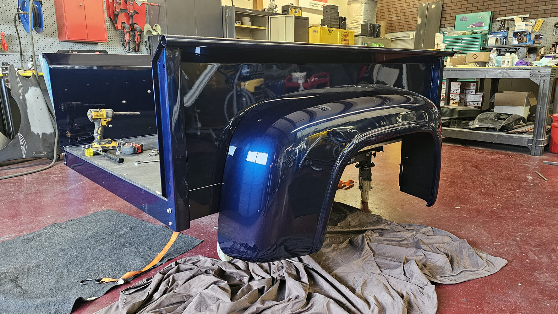 28 1956 Ford F 100 full bed assembly nearing completion with rear fender mounted