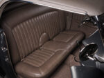 30 1936 Ford highboy brown leather bench seat with custom stitching seatbelts and shifter visible in cabin