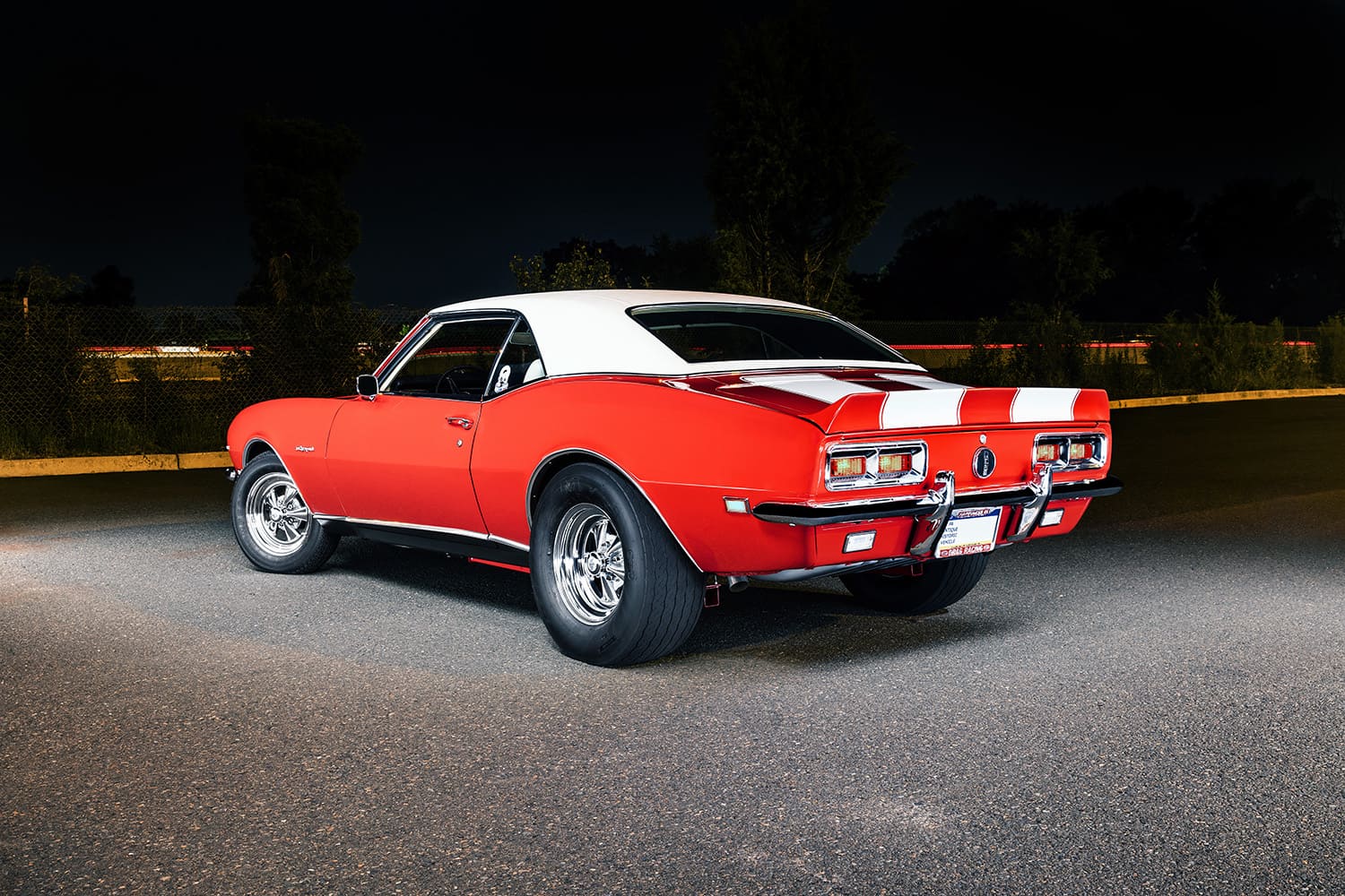 003 1968 Chevrolet Camaro rear three quarter with drag slicks and chrome bumper guards