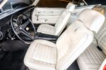 011 1968 Chevrolet Camaro interior with ivory bucket seats woodgrain console and black dash trim