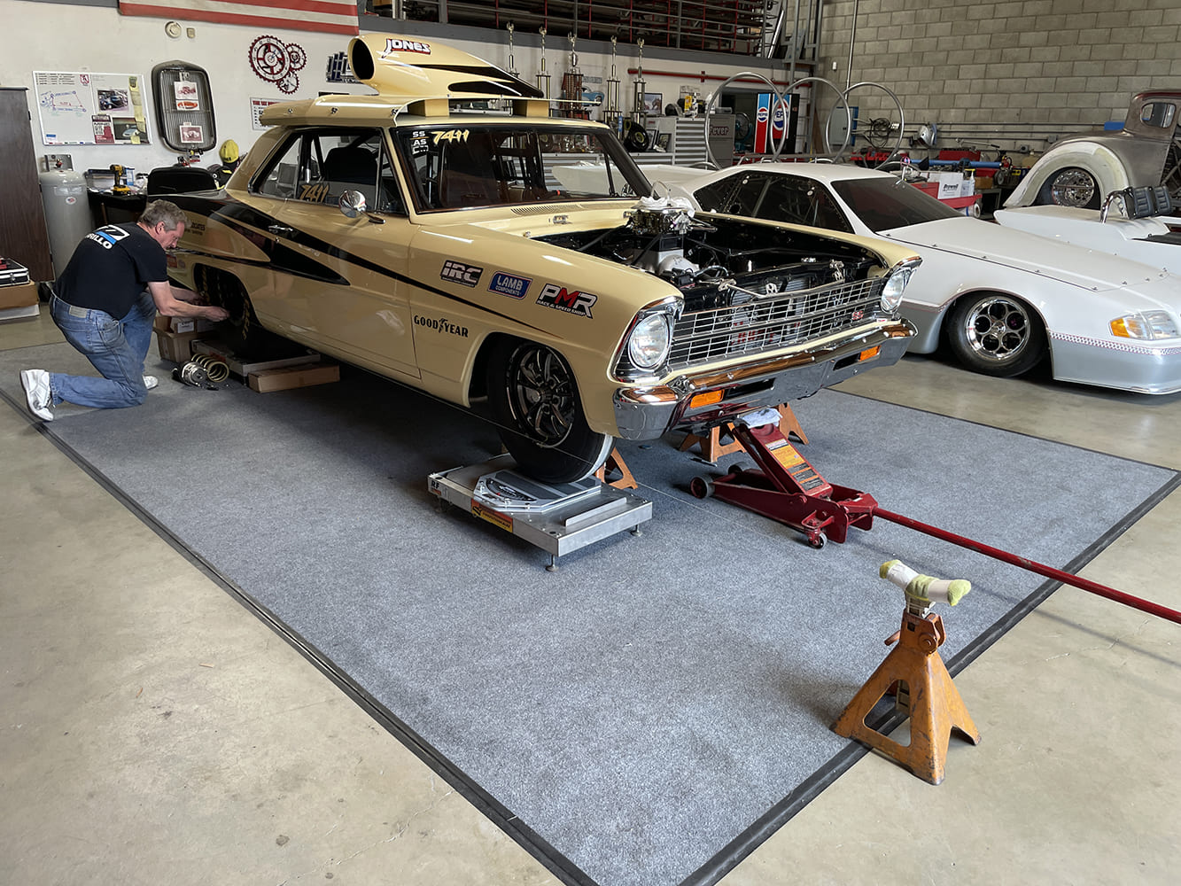 013 1966 nova drag car on scales during suspension alignment in race shop