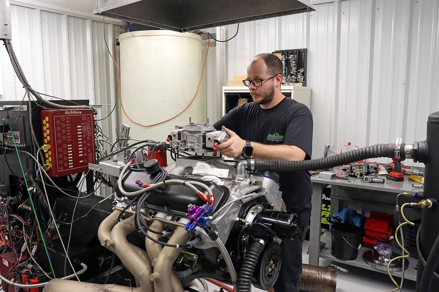 014 Engine dyno room with technician tuning carbureted big block for optimal horsepower output