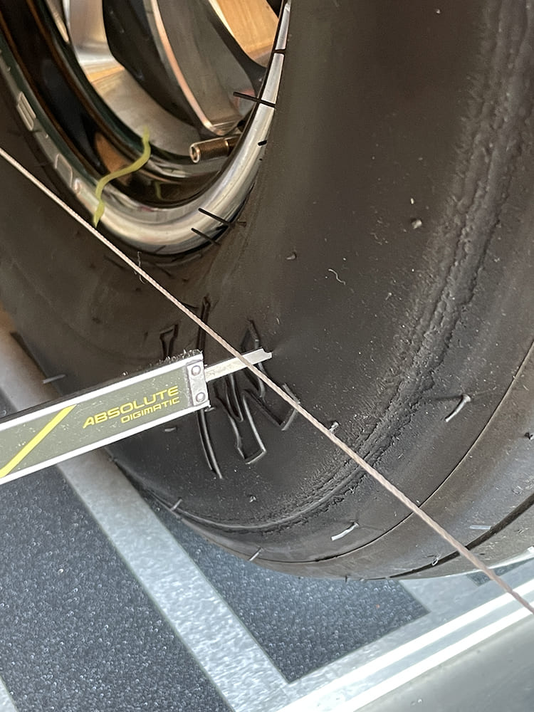 018 close up of toe measurement from string to slick with caliper