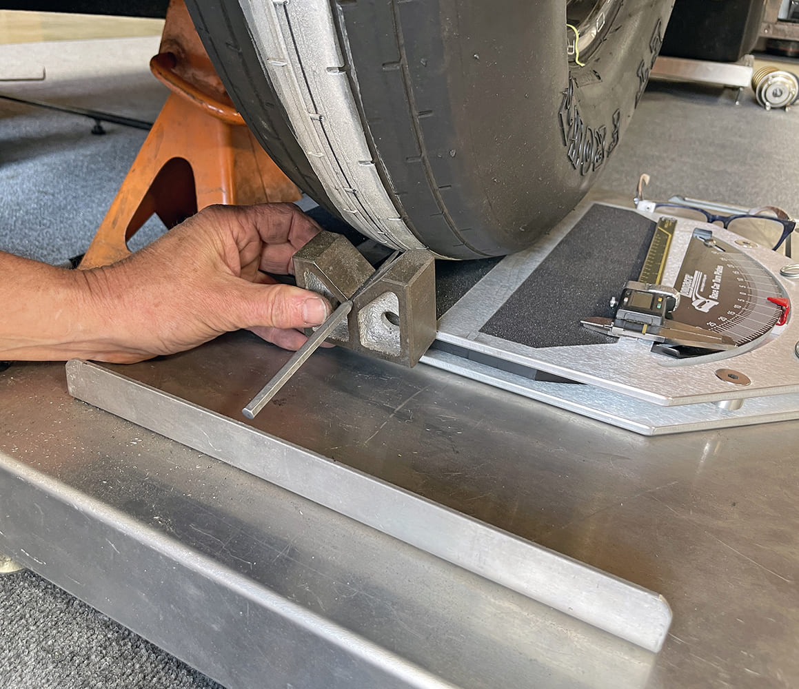 027 checking rear axle square to front tire with magnetic base