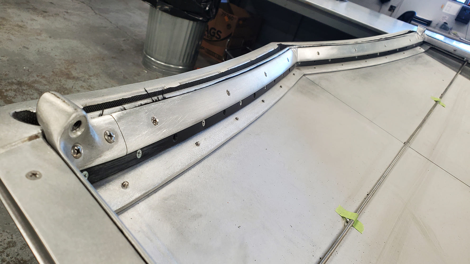 12 1936 Ford Roadster raw aluminum top structure windshield mount bracket detail and perimeter seal channel