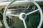 17 1969 Ford F 250 white Delmo horn cap on classic steering wheel above green loop carpet