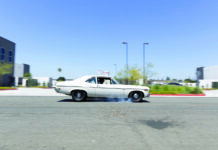 000 1969 Chevy Nova burnout black steelies street action shot