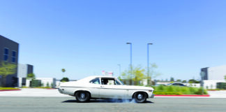 000 1969 Chevy Nova burnout black steelies street action shot