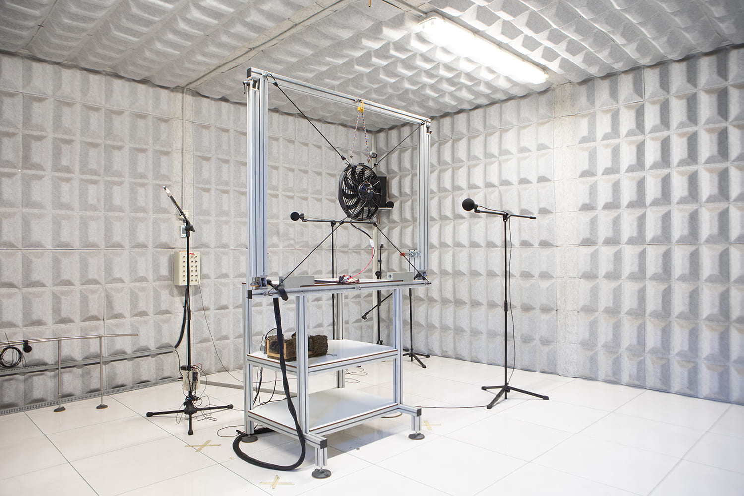 002 Brushless electric fan undergoing noise and performance testing in anechoic sound chamber