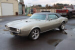 01 1967 Pontiac Firebird 400 hardtop with Rally II wheels and silver paint parked on wet asphalt