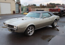 1967 Pontiac Firebird Sits on a Roadster Shop Chassis 01 1967 Pontiac Firebird 400 hardtop with Rally II wheels and silver paint parked on wet asphalt