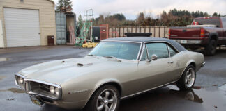 01 1967 Pontiac Firebird 400 hardtop with Rally II wheels and silver paint parked on wet asphalt