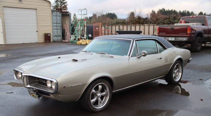 1967 Pontiac Firebird Sits on a Roadster Shop Chassis 01 1967 Pontiac Firebird 400 hardtop with Rally II wheels and silver paint parked on wet asphalt