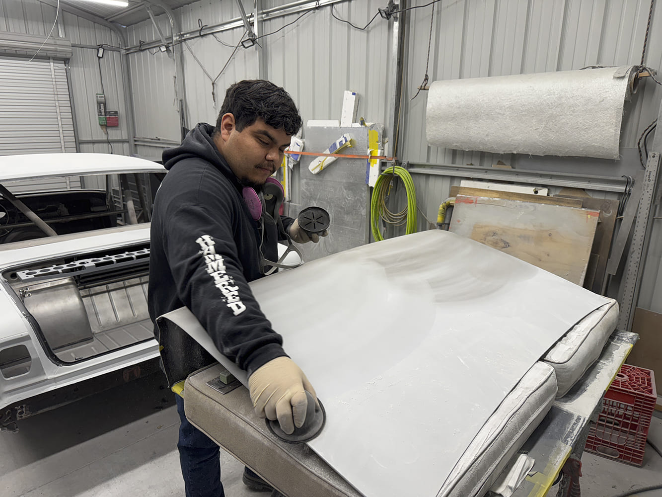 011 Bodyman sanding 1963 Chevy Nova hood with DA sander