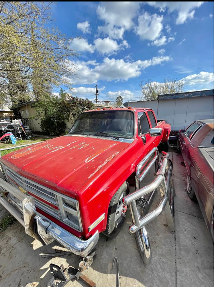 02 1985 chevy squarebody crew cab red patina dually with bull bar and smoked cab lights
