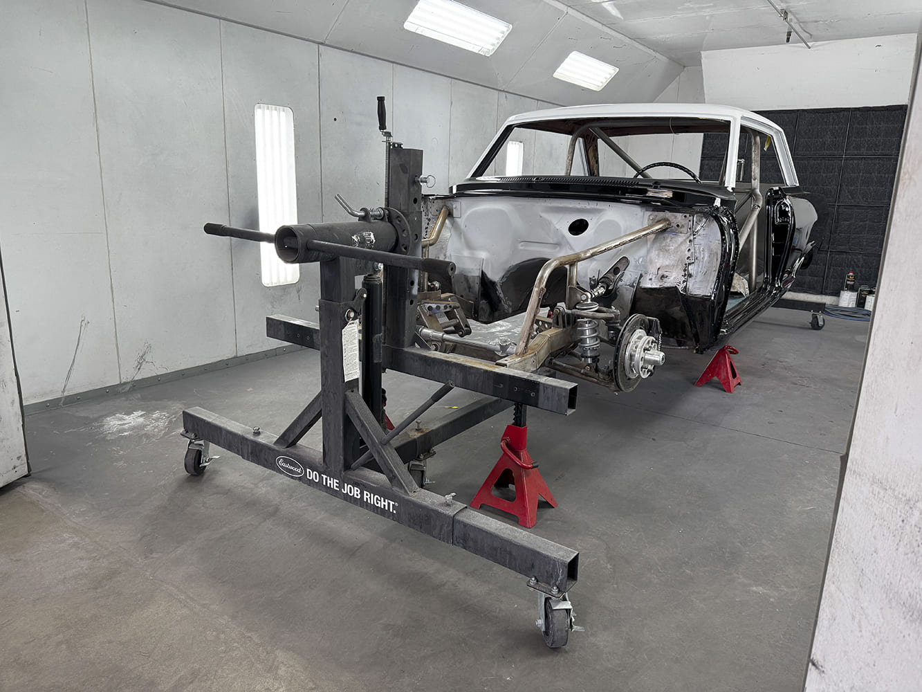 023 1963 Chevy Nova body on rotisserie front suspension Wilwood brakes visible