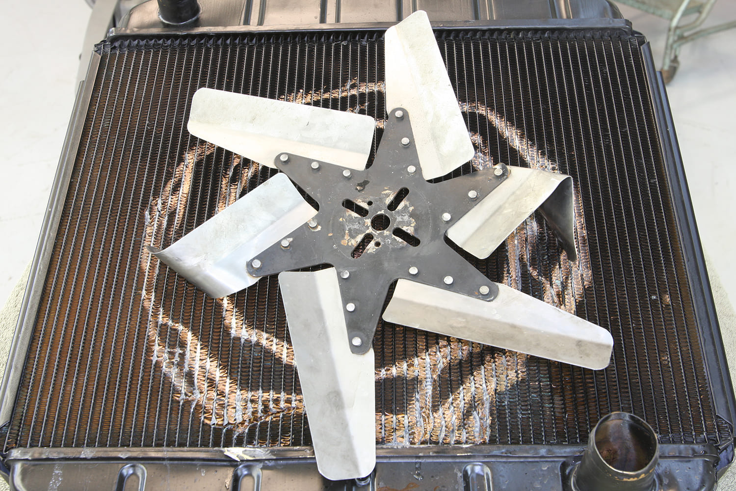 026 Bent flex fan from radiator impact – evidence of contact from improper fit or fan failure