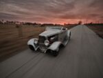 03 1932 Ford Roadster rolling in raw steel red sunset background open headers